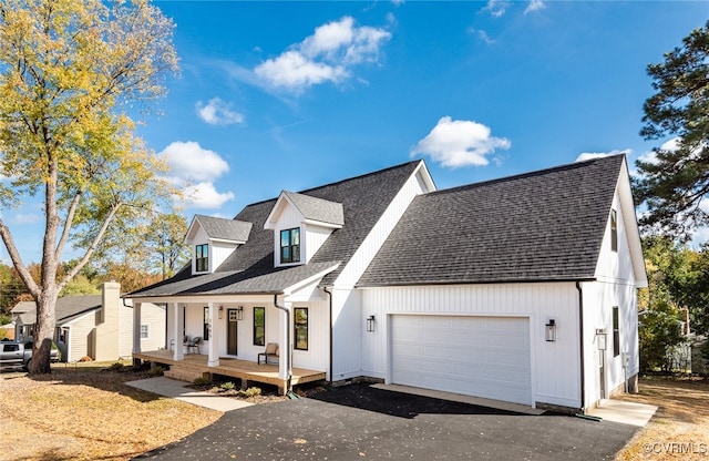 view of front of house featuring a porch and a garage