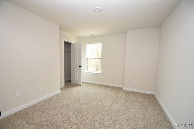 unfurnished room with light carpet