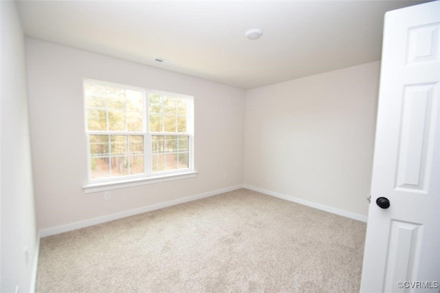 spare room with light colored carpet