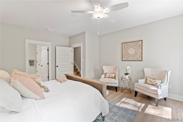 bedroom with ceiling fan and light hardwood / wood-style flooring