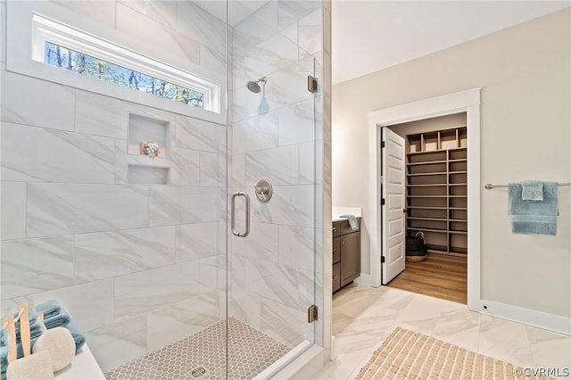 bathroom with vanity and a shower with shower door