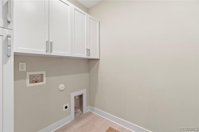 clothes washing area with cabinets, hookup for a gas dryer, washer hookup, light tile patterned floors, and hookup for an electric dryer