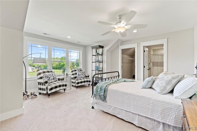 bedroom featuring carpet flooring, ceiling fan, a walk in closet, and a closet