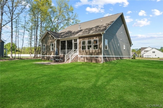 rear view of property featuring a lawn and a patio area