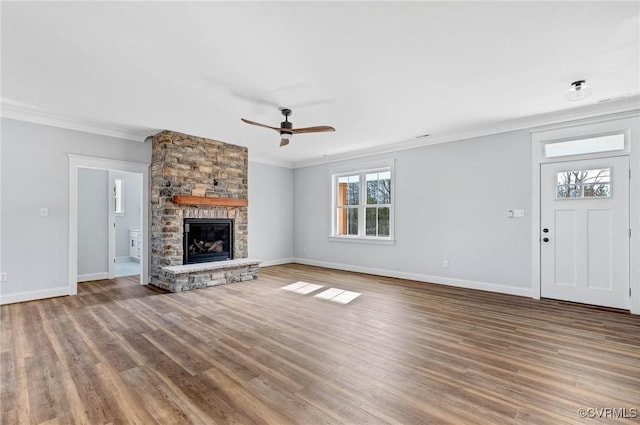 unfurnished living room with crown molding, a fireplace, ceiling fan, and wood-type flooring