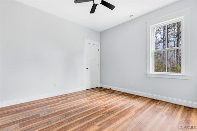 empty room featuring light hardwood / wood-style flooring and ceiling fan