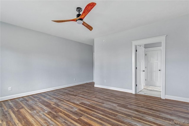 empty room with ceiling fan and dark hardwood / wood-style flooring