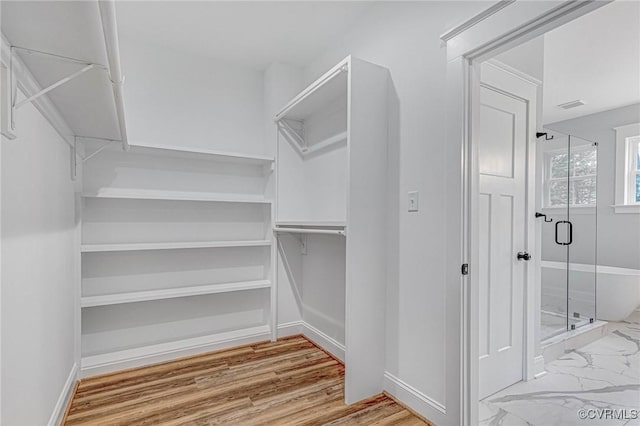 spacious closet featuring hardwood / wood-style floors