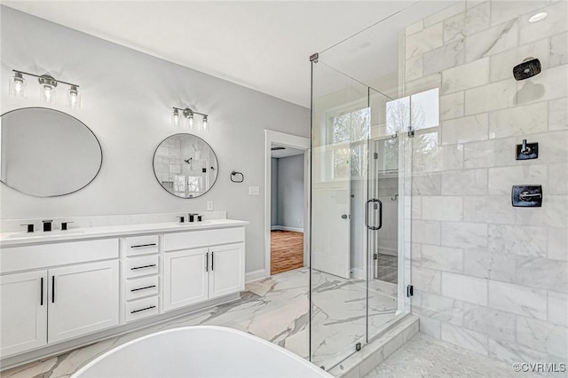 bathroom with vanity and shower with separate bathtub