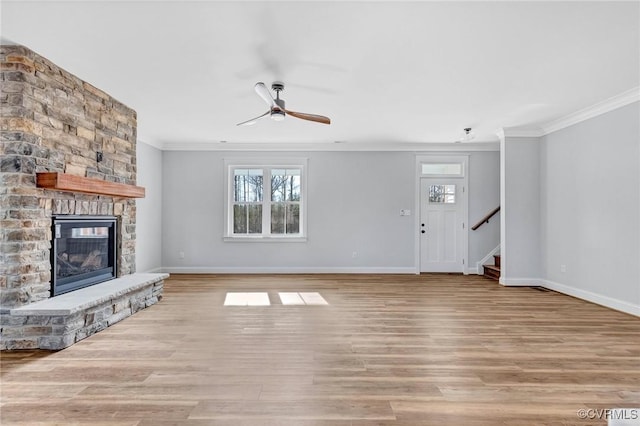 unfurnished living room featuring a stone fireplace, ornamental molding, and light wood-type flooring