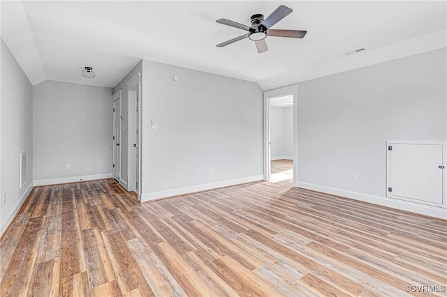 unfurnished room featuring ceiling fan, lofted ceiling, and light hardwood / wood-style flooring