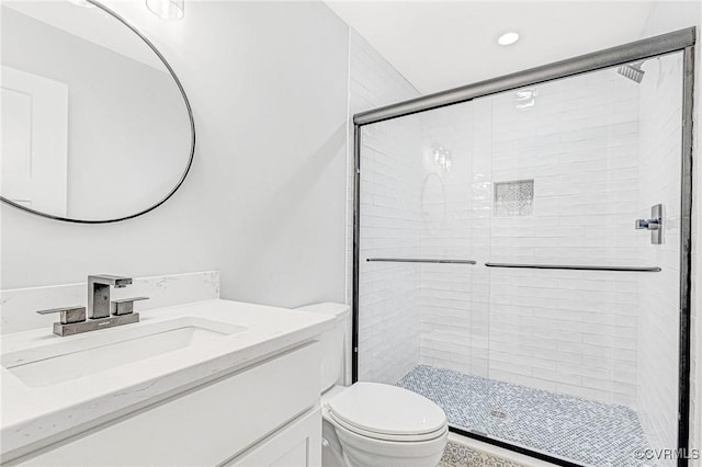 bathroom with vanity, toilet, and walk in shower