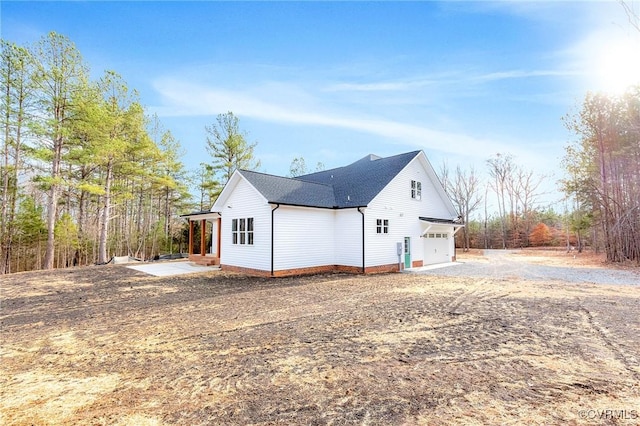 view of side of property with a garage