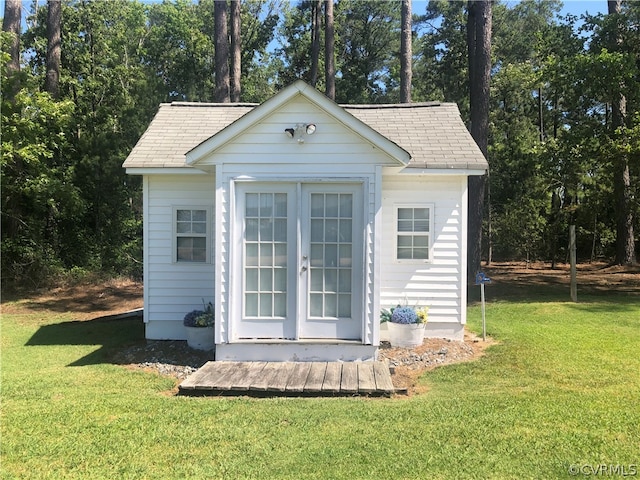 view of outdoor structure featuring a lawn