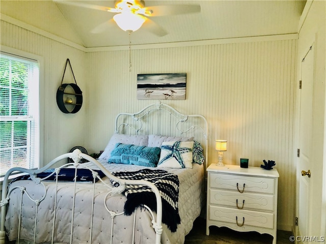 bedroom with crown molding, lofted ceiling, and ceiling fan