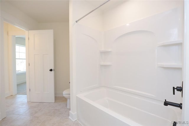 bathroom featuring shower / bath combination, tile patterned flooring, and toilet