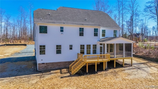 rear view of property featuring a sunroom and a deck