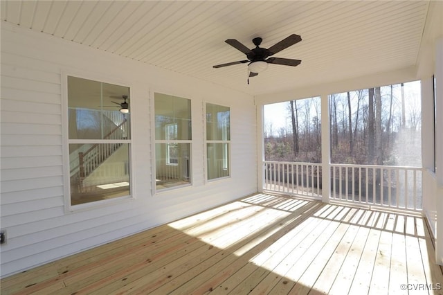 unfurnished sunroom featuring wooden ceiling and ceiling fan