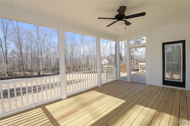 unfurnished sunroom featuring ceiling fan