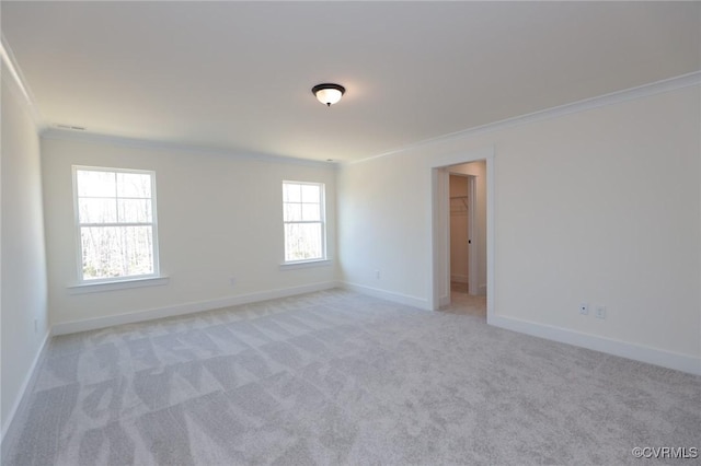 spare room featuring crown molding and light colored carpet