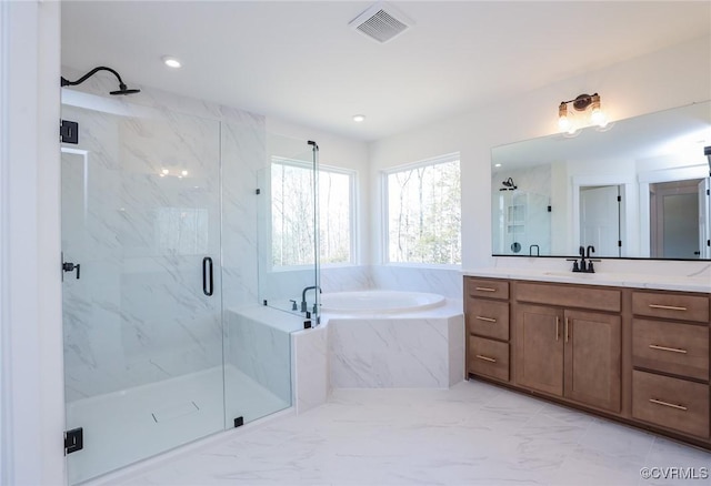 bathroom featuring vanity and shower with separate bathtub