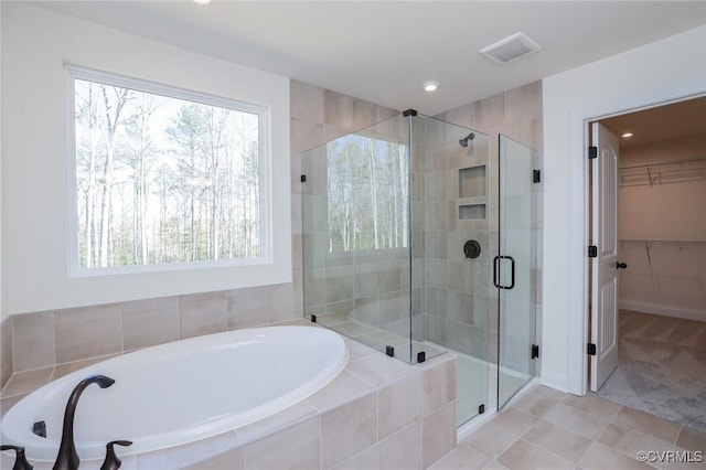 bathroom with plus walk in shower and tile patterned flooring