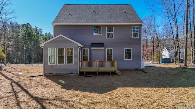 back of property with a lawn and a deck