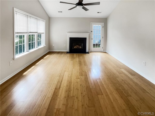 unfurnished living room featuring ceiling fan, a healthy amount of sunlight, and light hardwood / wood-style floors