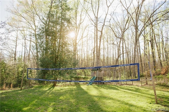 view of community featuring volleyball court and a yard