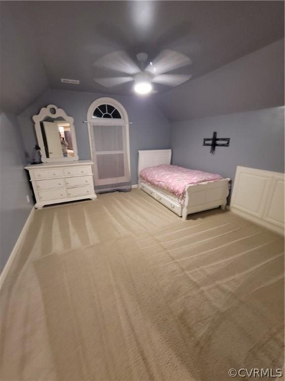 unfurnished bedroom with light carpet, vaulted ceiling, and ceiling fan