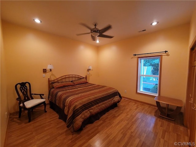 bedroom with hardwood / wood-style flooring and ceiling fan