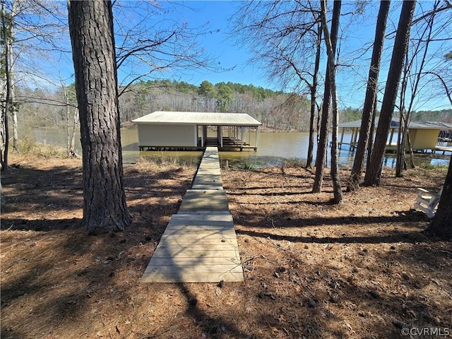 view of front of property with a boat dock and a water view