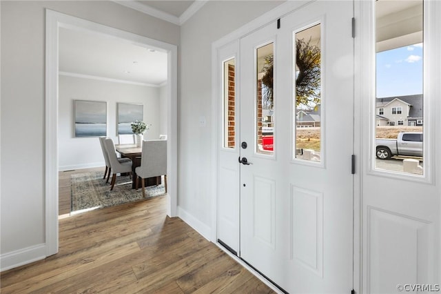 entryway with wood-type flooring and ornamental molding