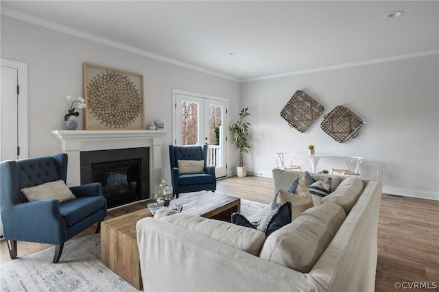 living room featuring light hardwood / wood-style floors and ornamental molding