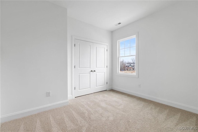 unfurnished bedroom with a closet and carpet flooring