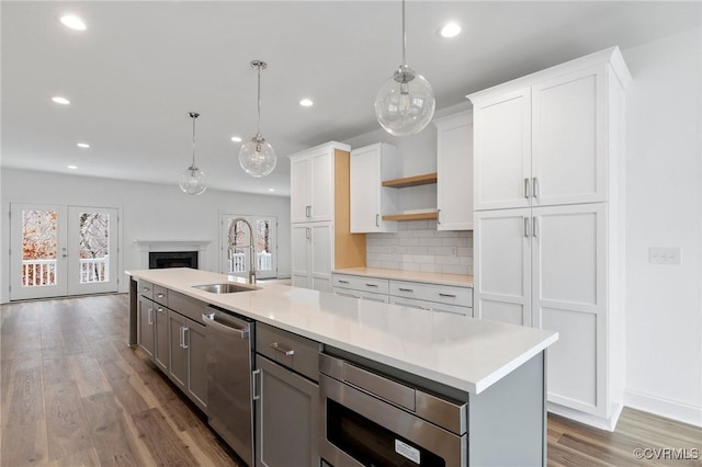 kitchen featuring appliances with stainless steel finishes, sink, and white cabinets