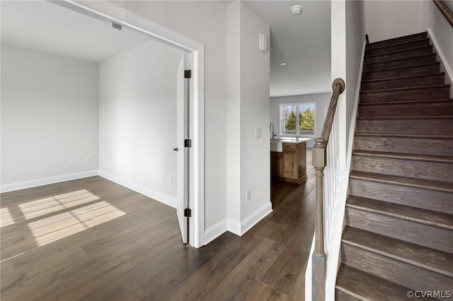 stairway with hardwood / wood-style floors