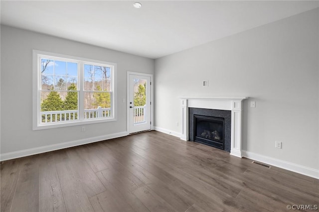 unfurnished living room featuring dark wood-type flooring