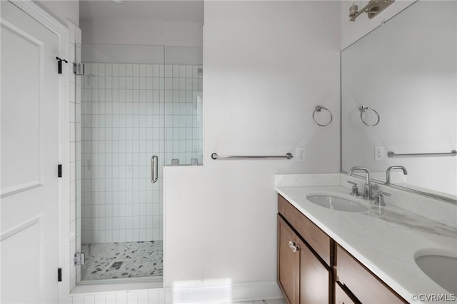 bathroom with vanity and a shower with door