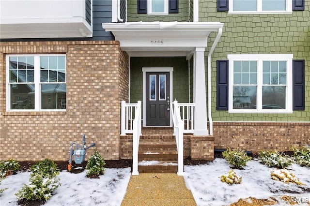 view of snow covered property entrance