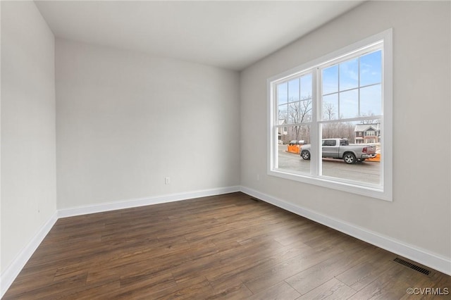 spare room with dark wood-type flooring