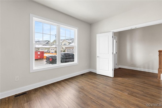 unfurnished room featuring dark wood-type flooring