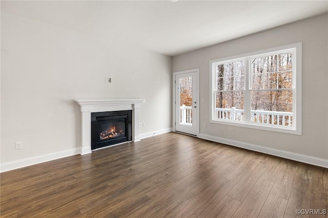 unfurnished living room featuring dark hardwood / wood-style floors