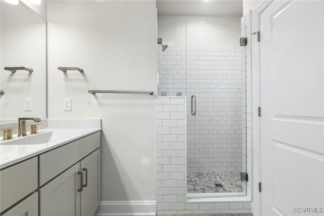 bathroom with vanity and a shower with door