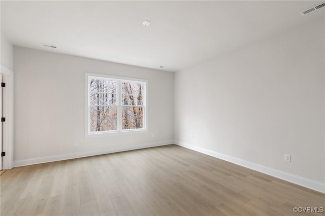 spare room featuring light hardwood / wood-style flooring