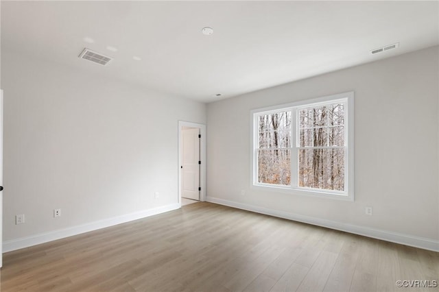 spare room featuring light wood-type flooring