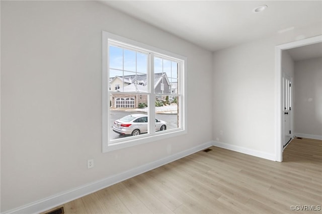 unfurnished room with light hardwood / wood-style flooring