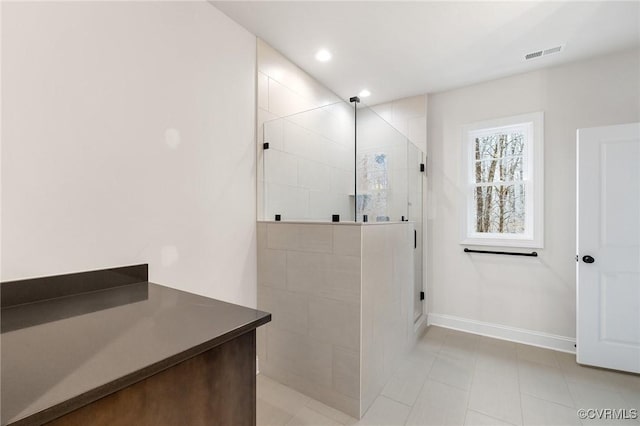 bathroom featuring a shower with shower door