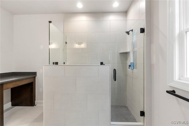 bathroom with a shower with shower door