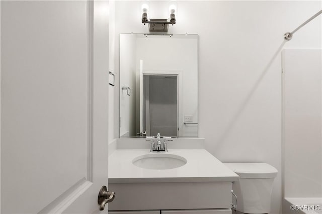 bathroom featuring vanity and toilet